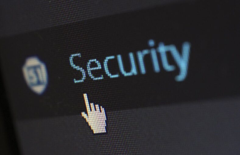 Close-up of a computer screen displaying a pointer cursor over the word "Security".